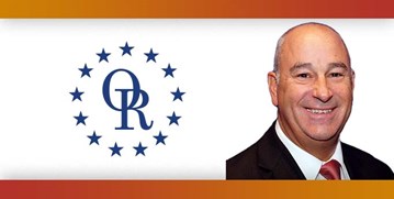 ORT logo with image of smiling bald man wearing suit with red tie.