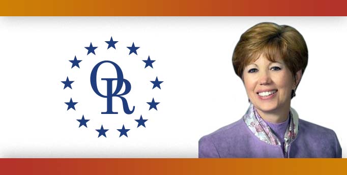 ORT logo with image of smiling woman with short hair wearing light purple shirt.
