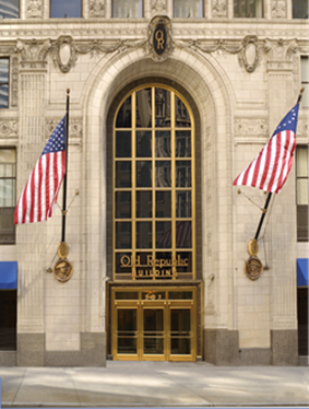 Exterior image of the front doors to the ORT Minneapolis building with two American flags.